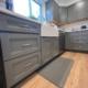 Kitchen remodel with grey cabinets and wood flooring